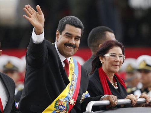 Ông Maduro và bà Flores vẫy tay chào mọi người trong một buổi lễ diều binh hồi tháng 4